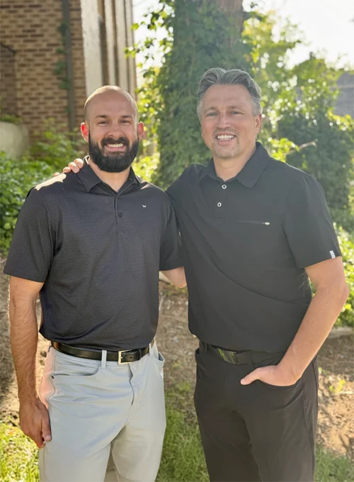 Dr. Adam Van Leeuwen and Dr. John Allen standing together outside of the Van Leeuwen Dental building