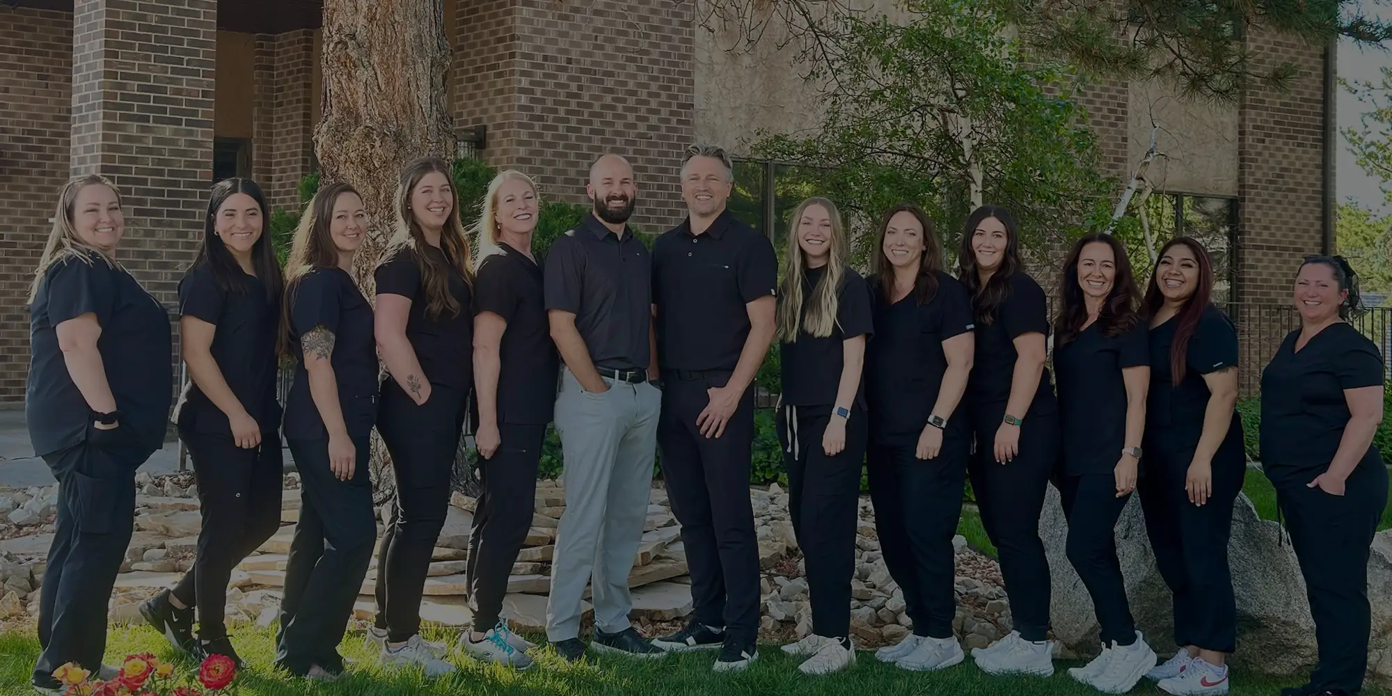 Dentist Cottonwood Heights UT Adam Van Leeuwen John Allen Team HPH v2 Drs. Adam Van Leeuwen and John Allen standing outside of the Van Leeuwen Dental building with their team